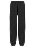 Pantalons décontractés en laine vierge noire de Givenchy, coupe élégante et moderne, visibles sur un mannequin.