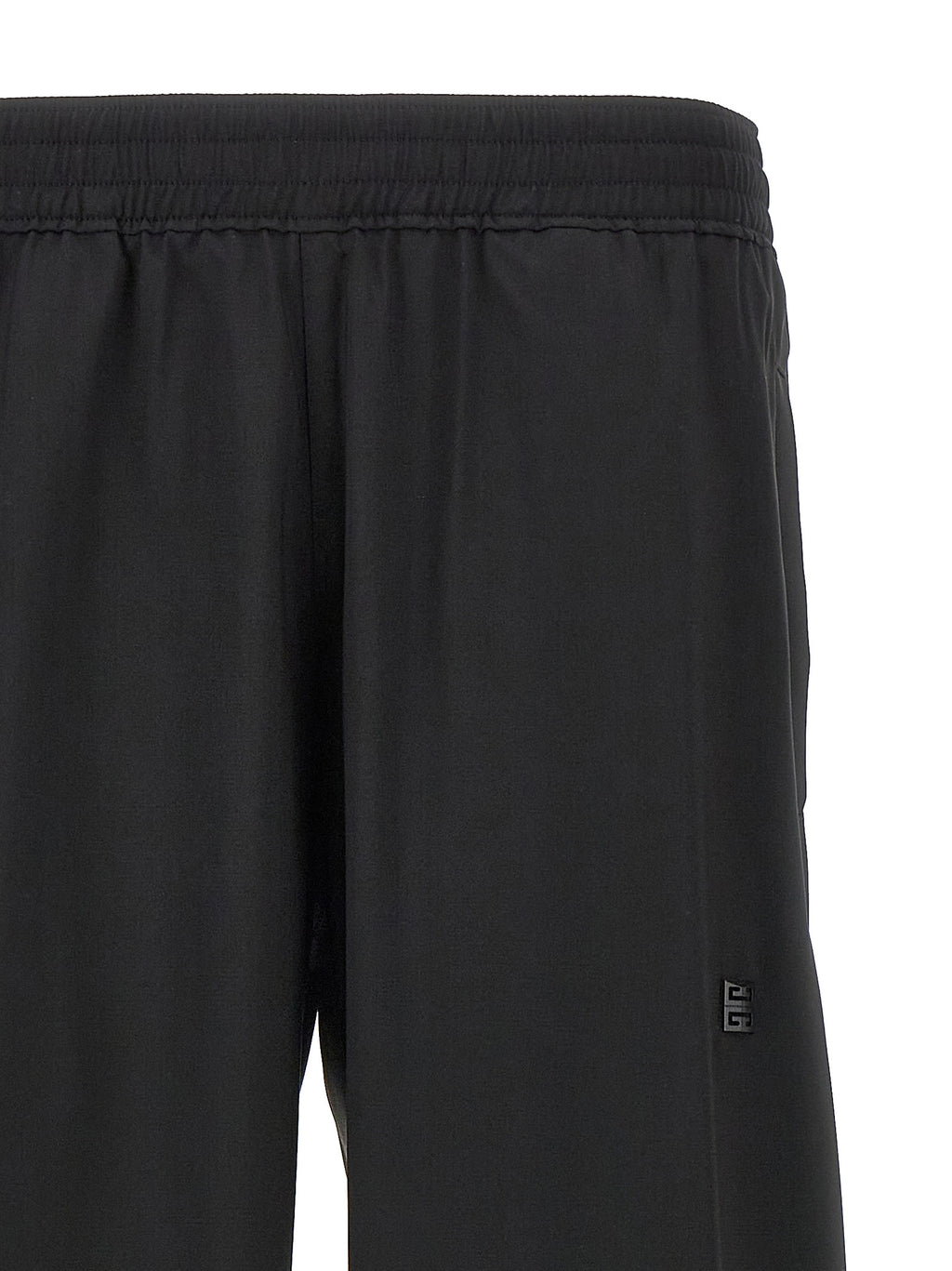 Pantalons décontractés en laine vierge noire de Givenchy, coupe élégante et tissu doux visible sur cette image.