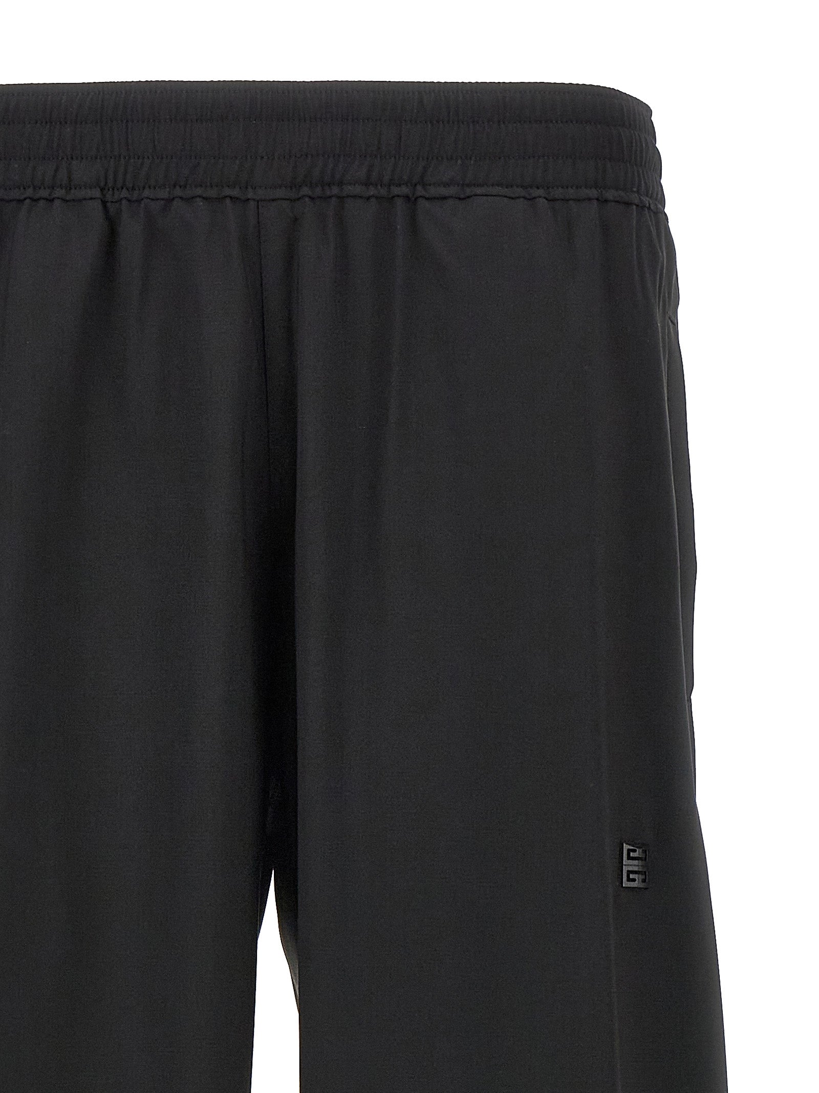 Pantalons décontractés en laine vierge noire de Givenchy, coupe élégante et tissu doux visible sur cette image.