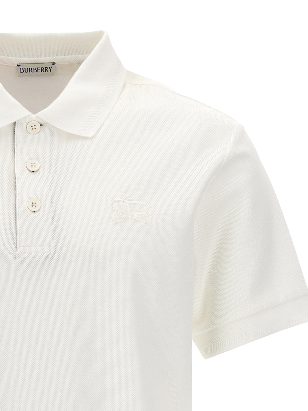 Chemise polo blanche en coton de la marque Burberry, avec col classique et logo emblématique visible.