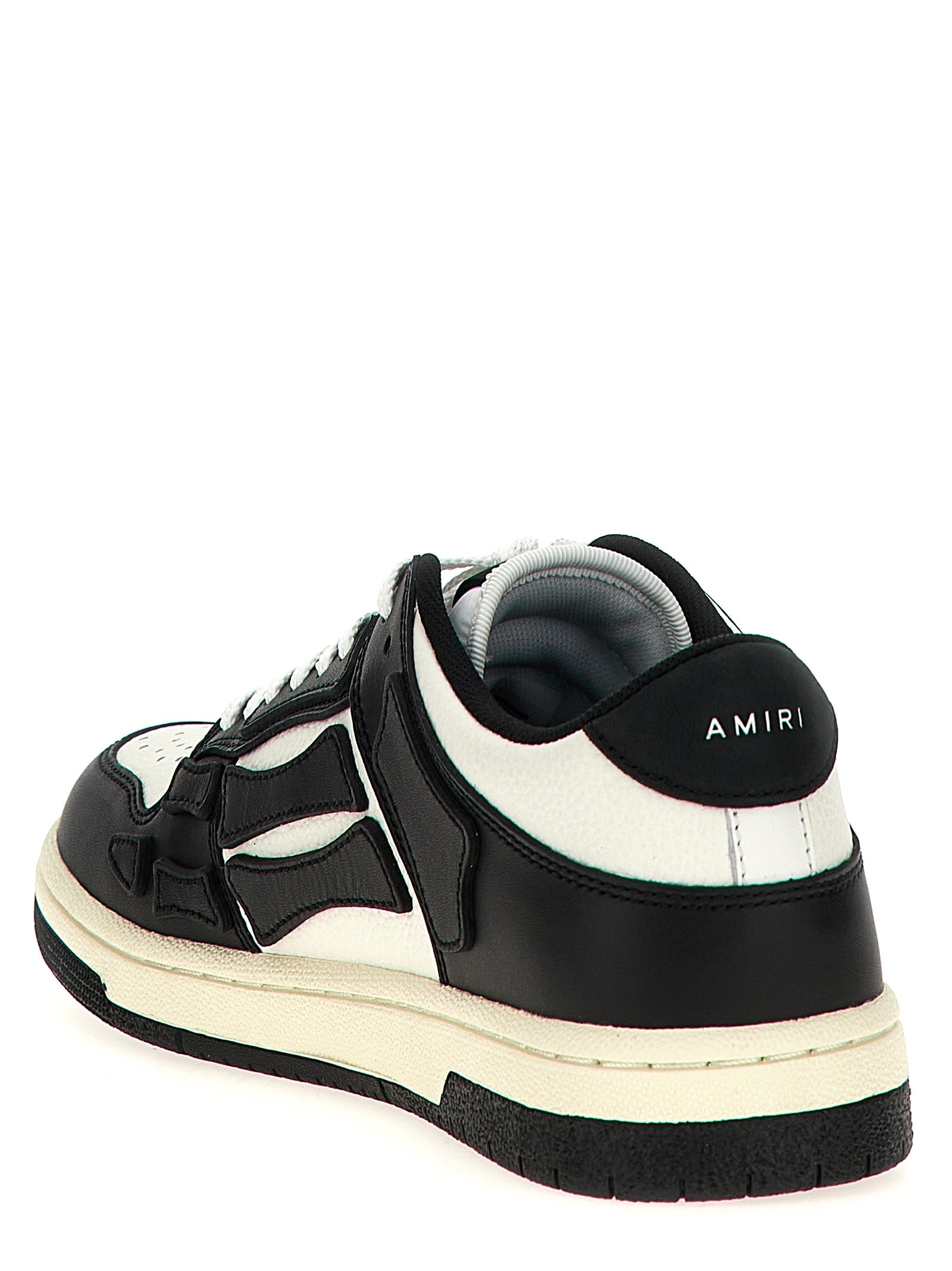 Baskets basses Amiri en cuir de vache bicolore, style moderne et tendance, avec semelle en caoutchouc et détails de design.