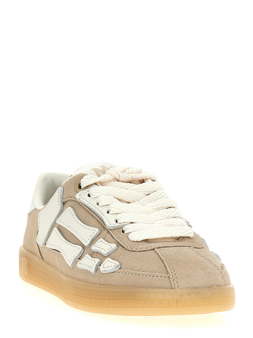 Sneakers beige en cuir de vachette de la marque Amiri, vue de face, avec détails de design modernes et semelle blanche.
