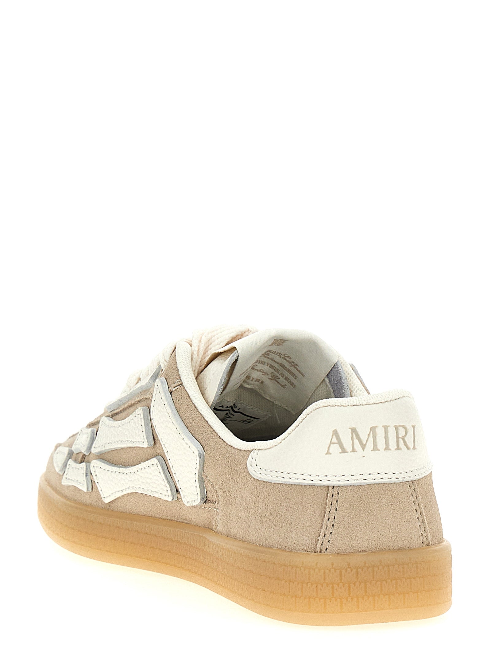 Sneakers beige en cuir de vache Amiri, à la mode, avec design moderne et détails tendance, pour un style décontracté et élégant.