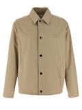 Veste longue beige en coton de la marque Burberry, vue de face, avec fermeture et détails classiques.