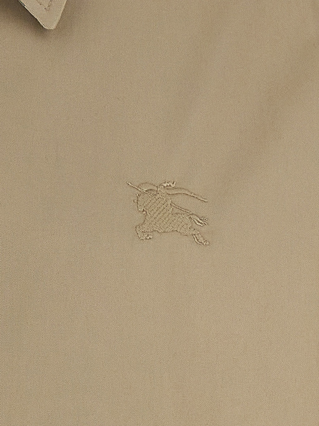 Veste longue en coton beige de Burberry, élégante, avec détails classiques et coupe ajustée, idéale pour un style sophistiqué.