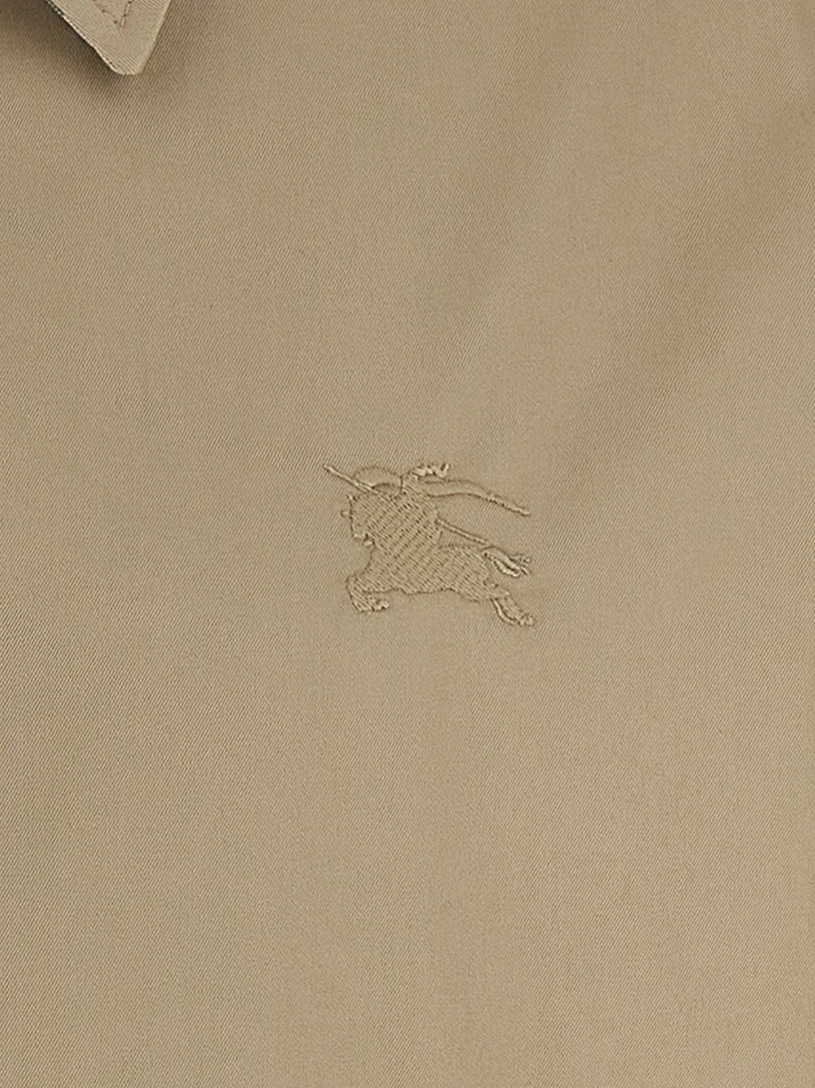 Veste longue en coton beige de Burberry, élégante, avec détails classiques et coupe ajustée, idéale pour un style sophistiqué.
