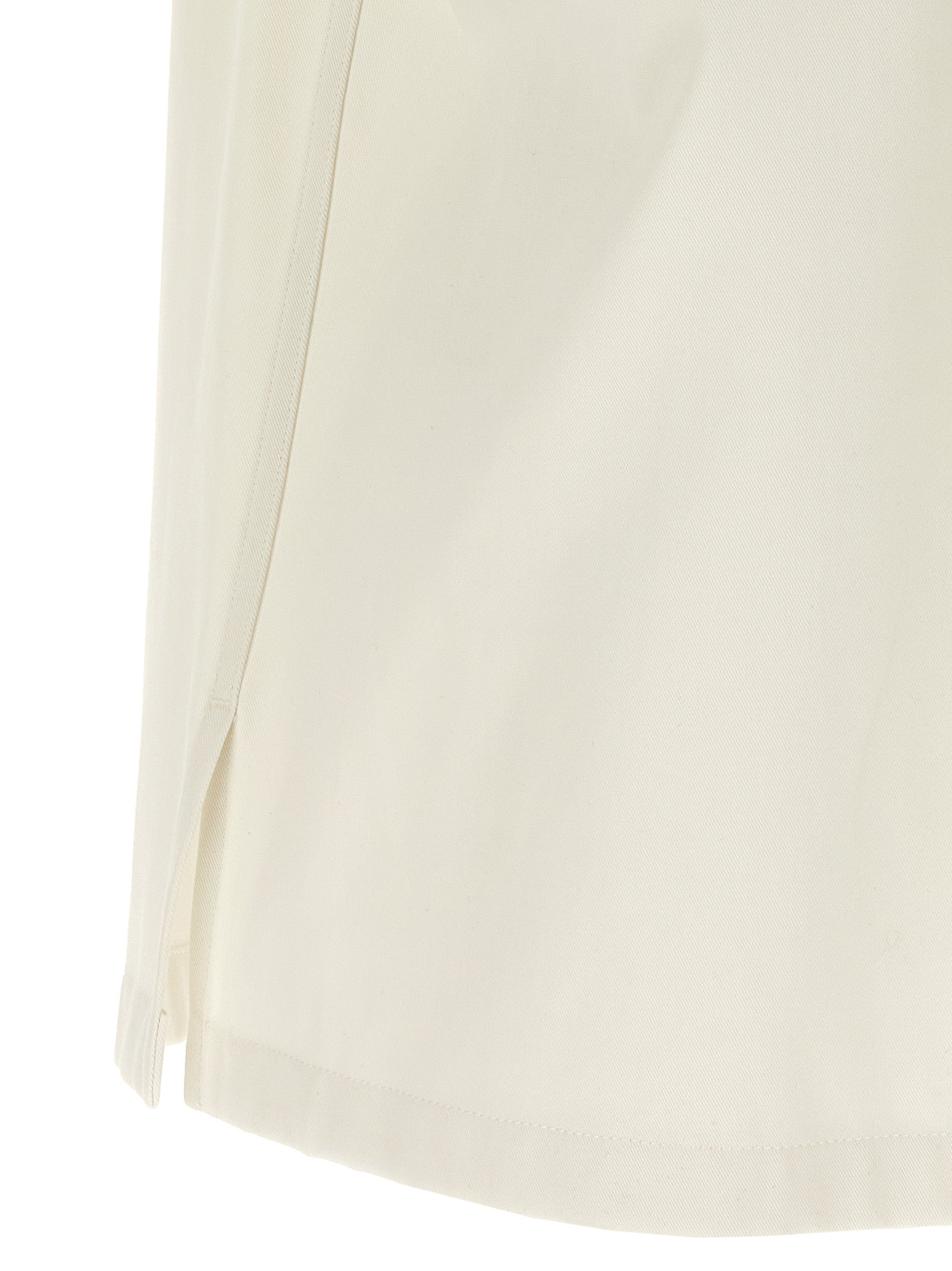Chemisier beige en coton de la marque Givenchy, avec détails élégants et coupe classique, porté sur un mannequin.