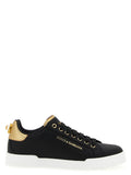 Sneakers noires en cuir de veau Dolce & Gabbana, design élégant et moderne, avec semelle blanche et détails sophistiqués.