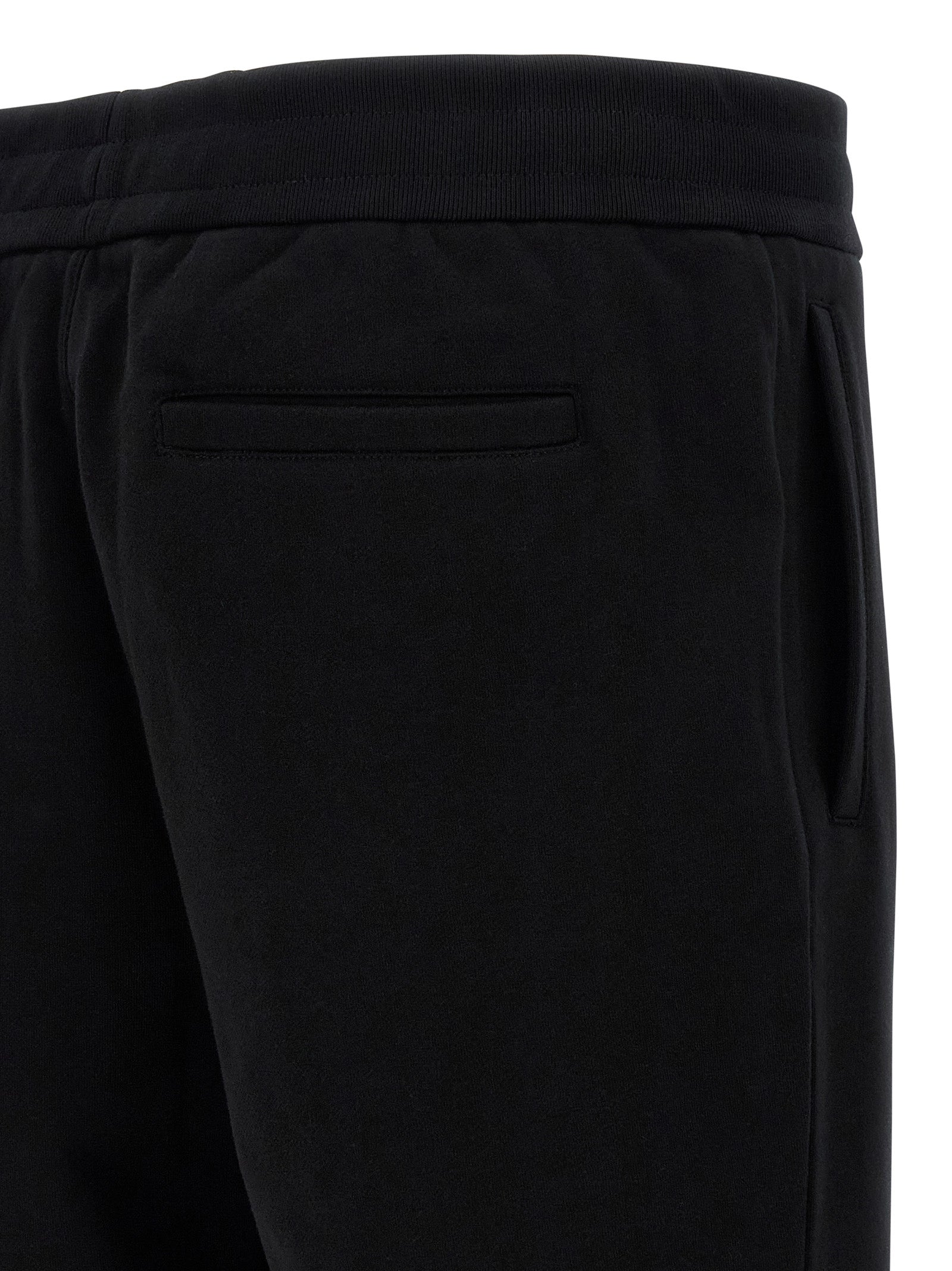 Pantalons de jogging noirs en coton Versace pour homme, style décontracté avec logo emblématique, confort pour la détente et l'entraînement.