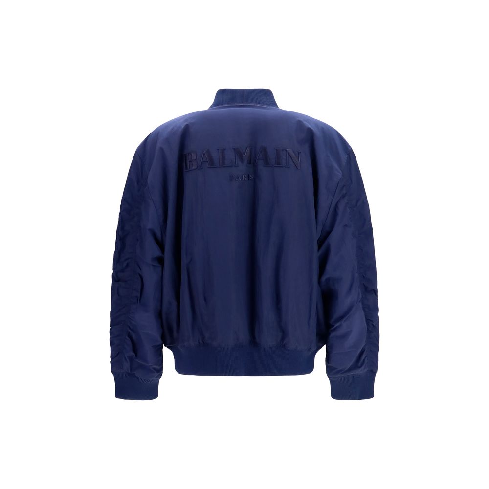 Veste bomber bleue en polyamide de Balmain, style moderne avec détails élégants, vue de face sur un fond neutre.
