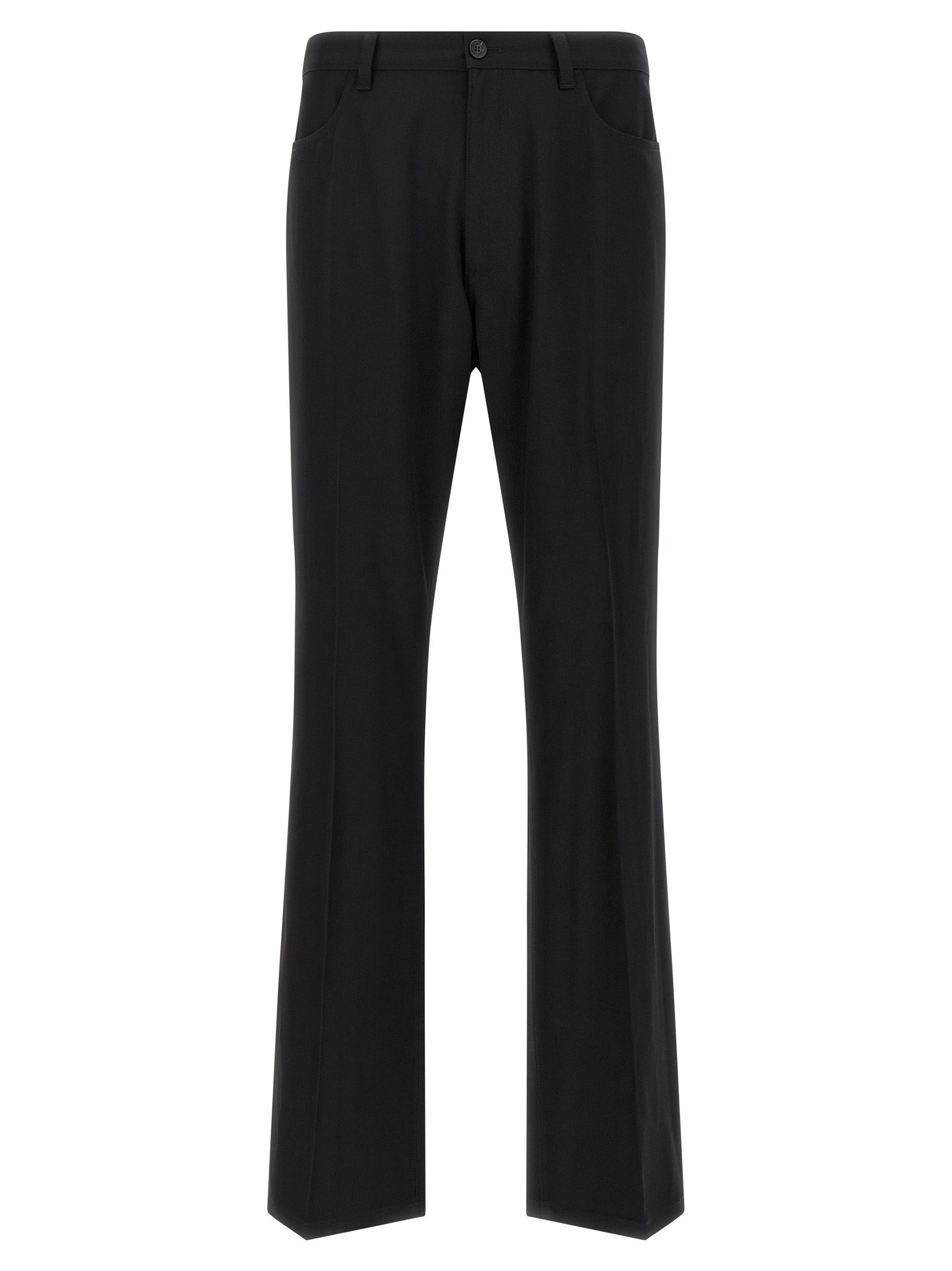 Pantalon en laine noir Balenciaga pour femme, coupe élégante et moderne, porté avec une chemise blanche.