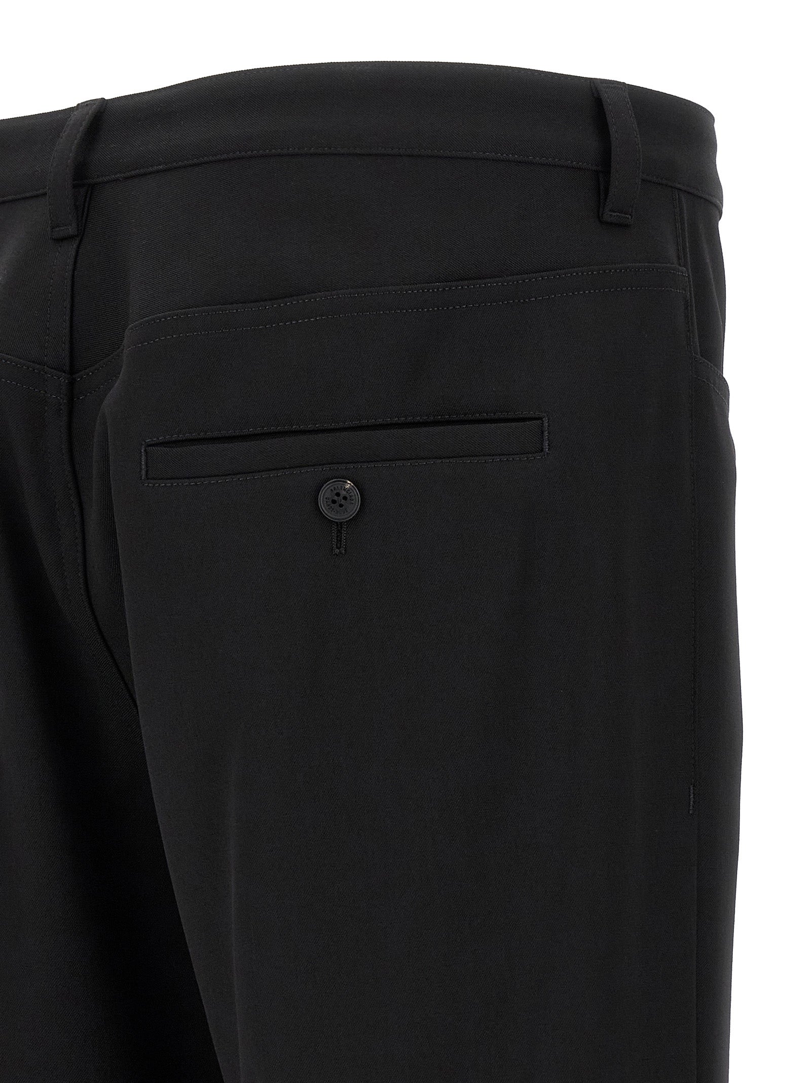 Pantalon habillé en laine noire de Balenciaga, style élégant et moderne, visible en détail dans l'image.