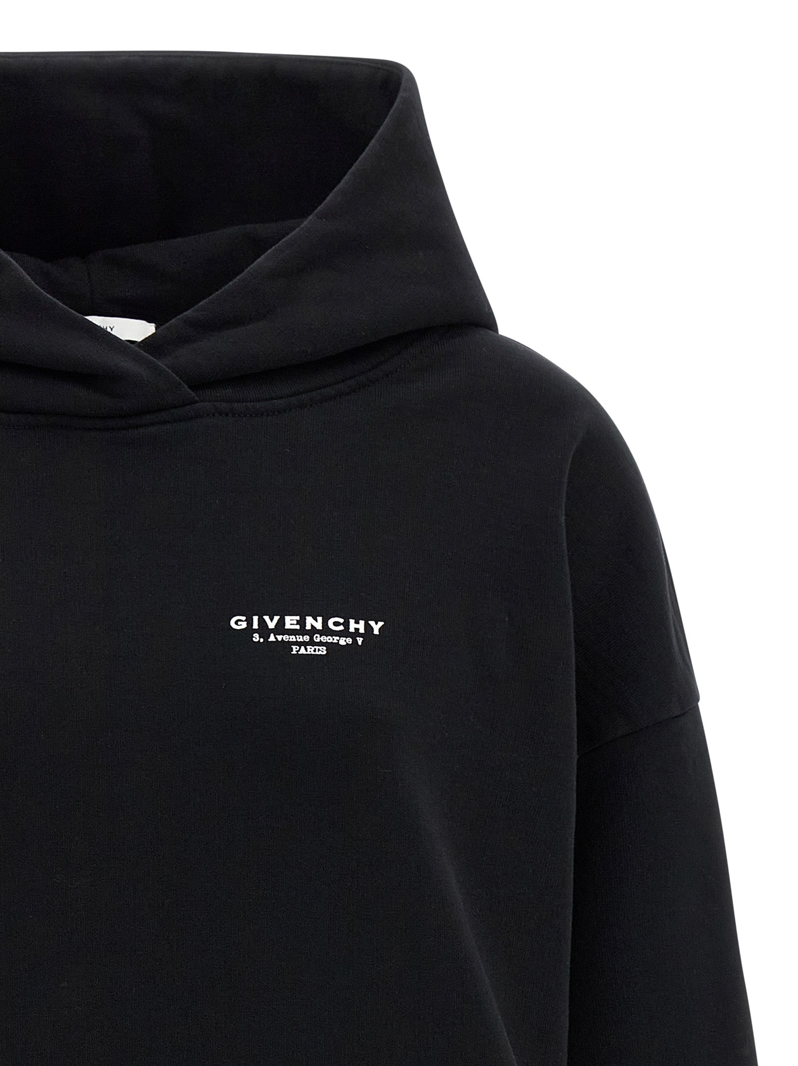 Sweat à capuche en coton bicolore Givenchy, noir et blanc, avec logo Givenchy sur la poitrine, vue de face.
