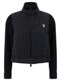 Cardigan en polyamide noir Moncler Grenoble avec fermeture éclair et col montant, présenté sur un mannequin.