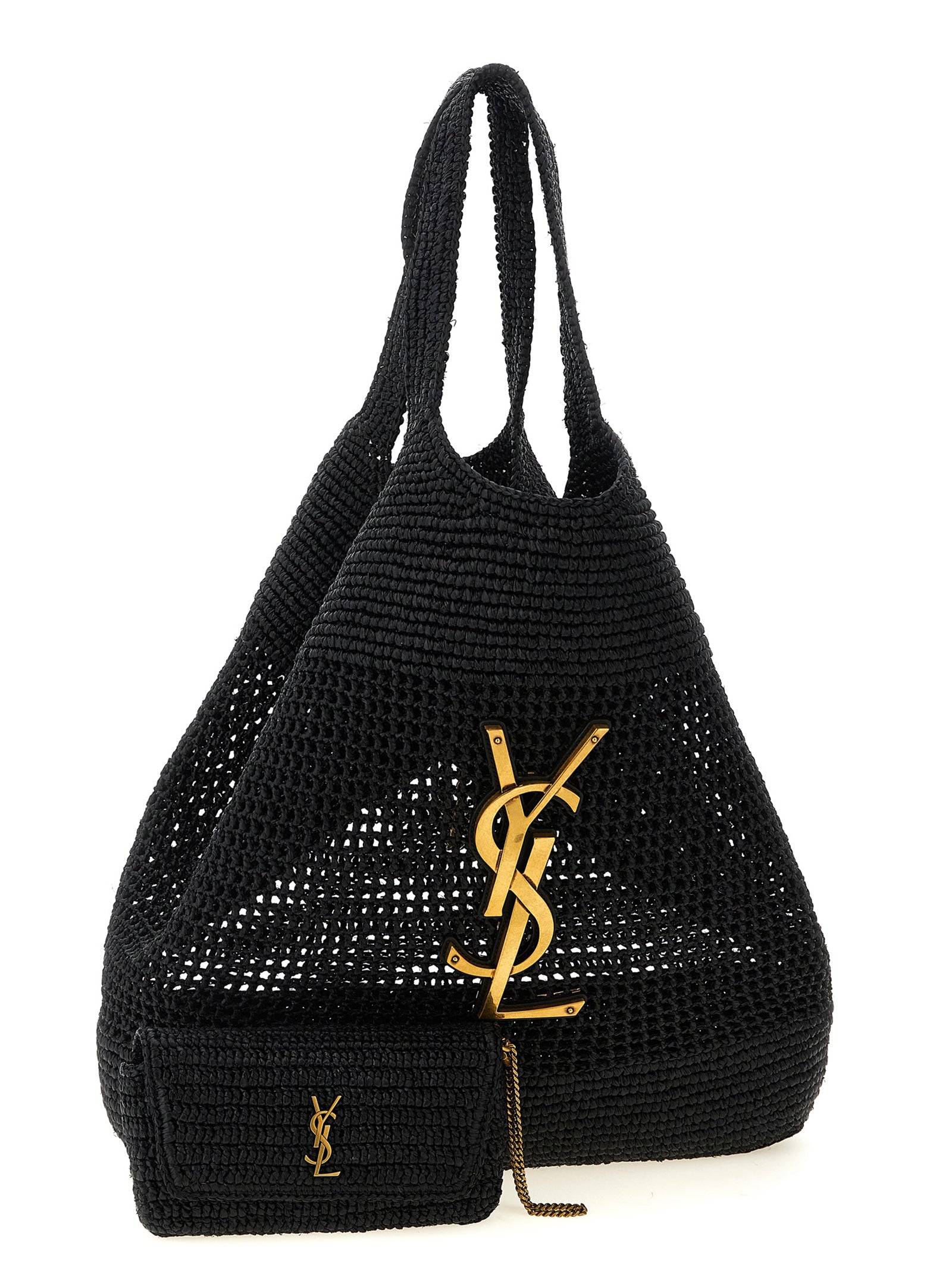 Sac cabas noir en raffia de Saint Laurent posé sur une surface en bois avec des poignées en cuir.