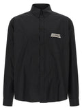 Chemise en coton noir de Balenciaga, détail du col et des manches, élégante et moderne.