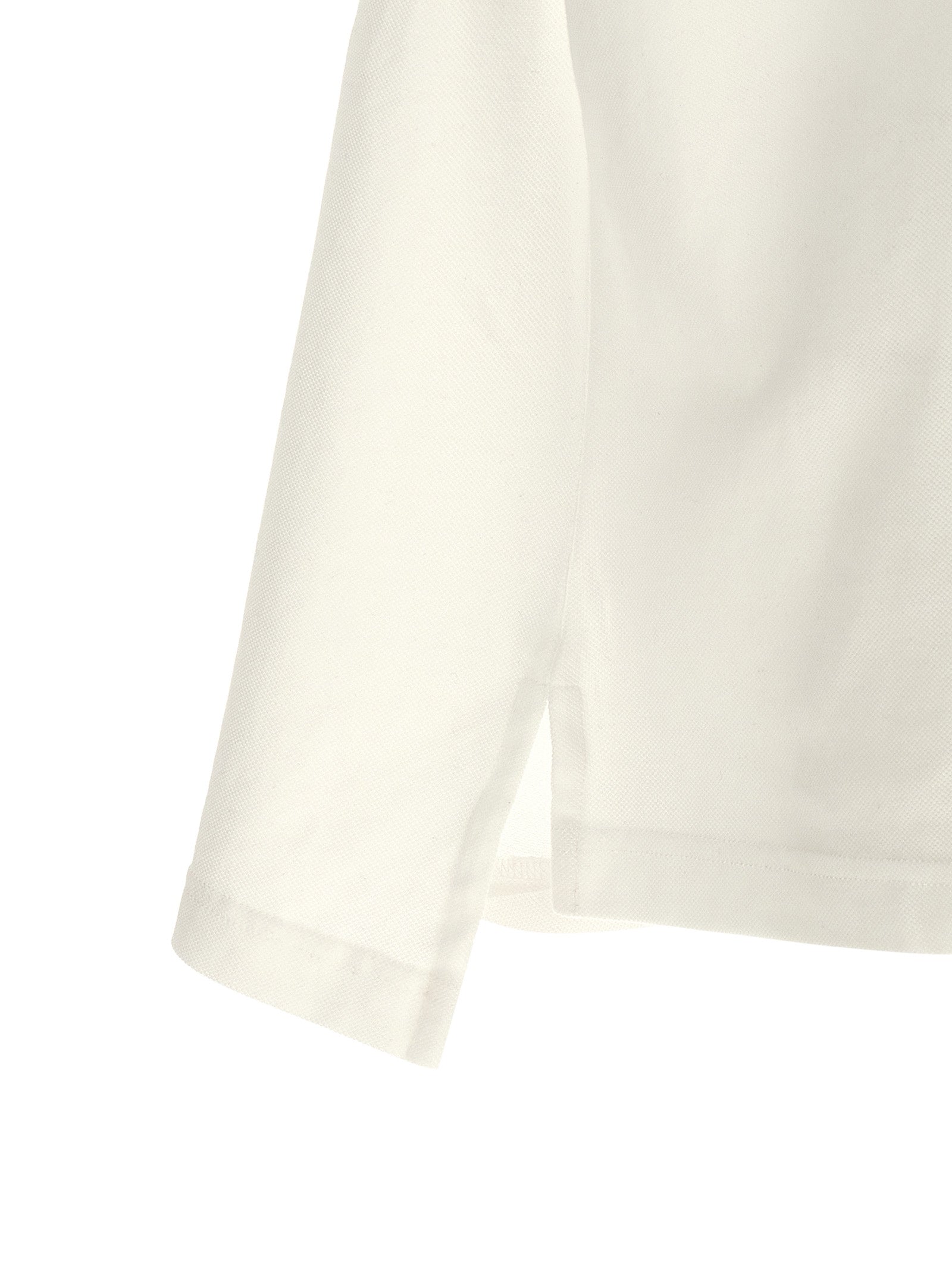 Chemise polo blanche en coton de Balenciaga, vêtement élégant avec col et boutons visibles.