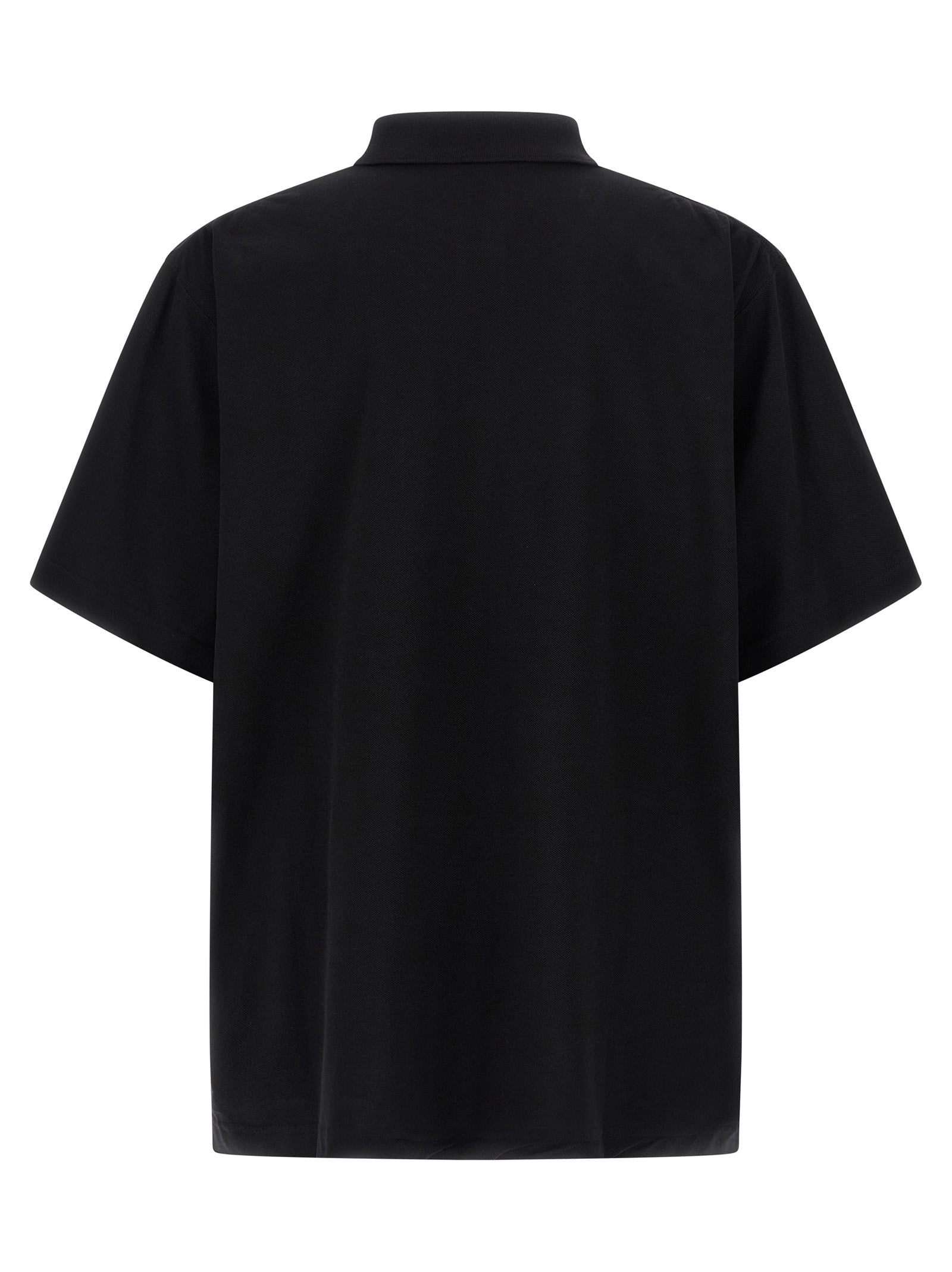 Chemise polo noire en coton de Balenciaga, vue de face, avec col classique et logo discret sur la poitrine.