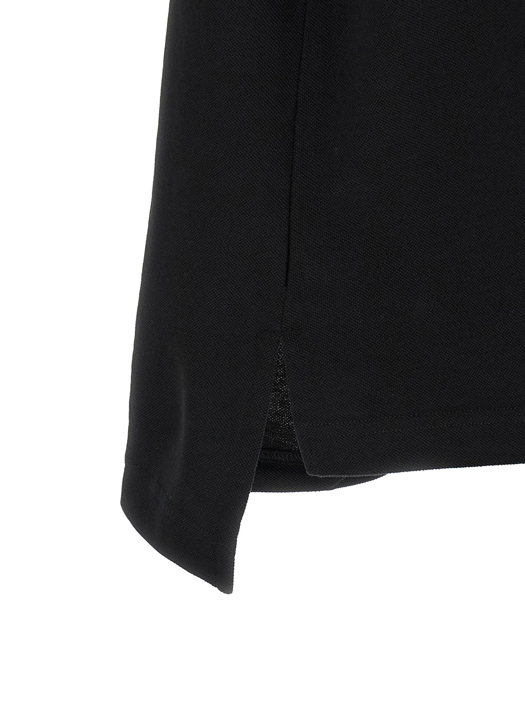 Chemise polo noire en coton de Balenciaga, vue de face, avec col classique et logo discret sur la poitrine.