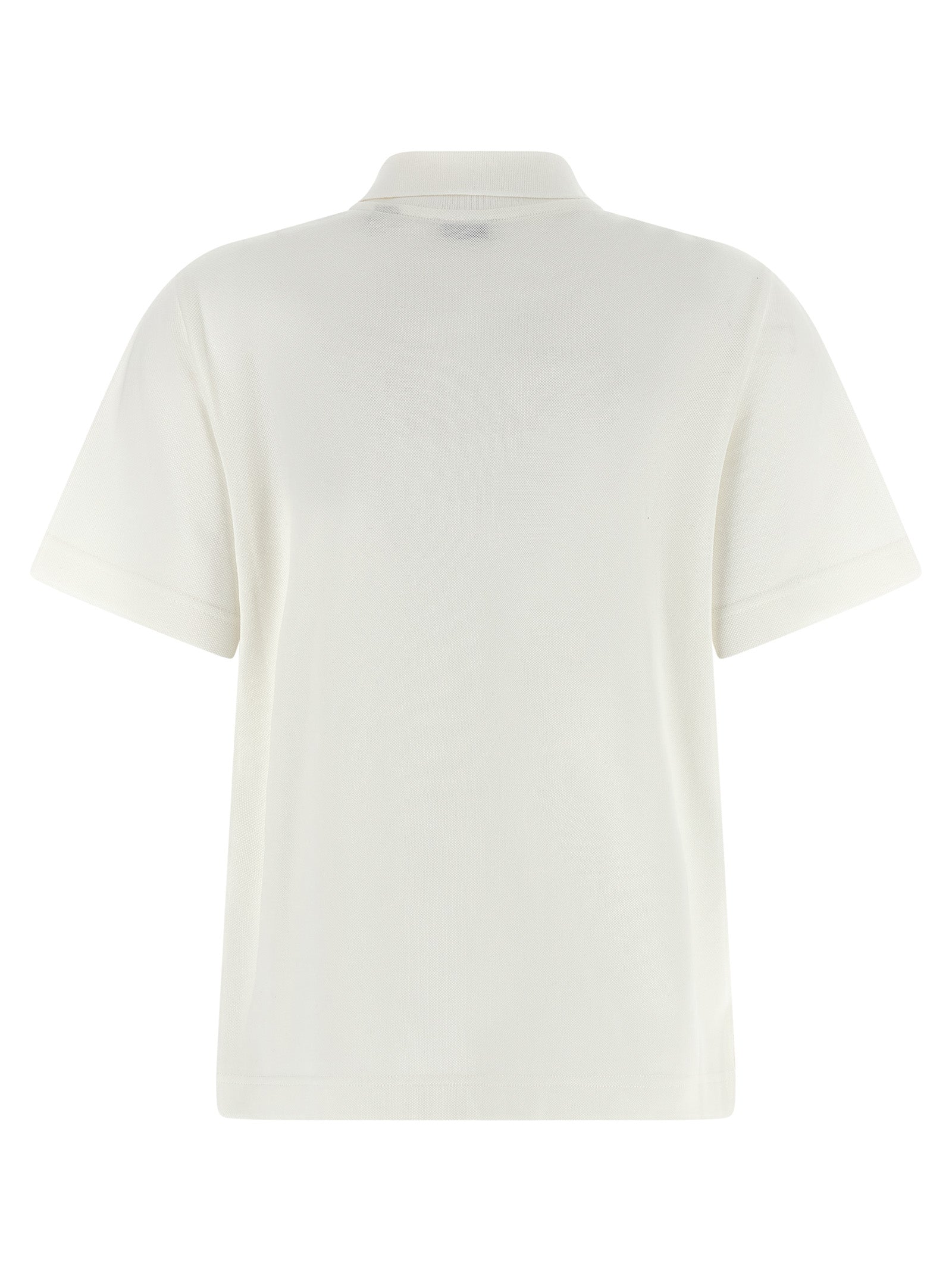 Chemise polo blanche en coton de la marque Burberry, avec col et boutons, portée dans un style décontracté.