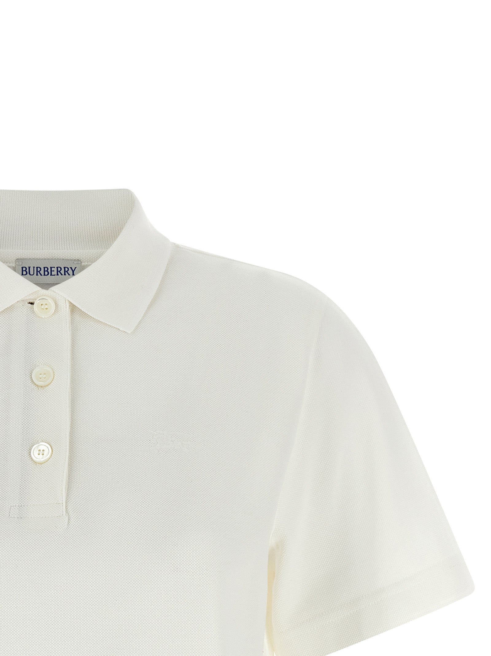 Chemise polo blanche en coton de la marque Burberry, avec col classique et logo discret visible sur l'image.