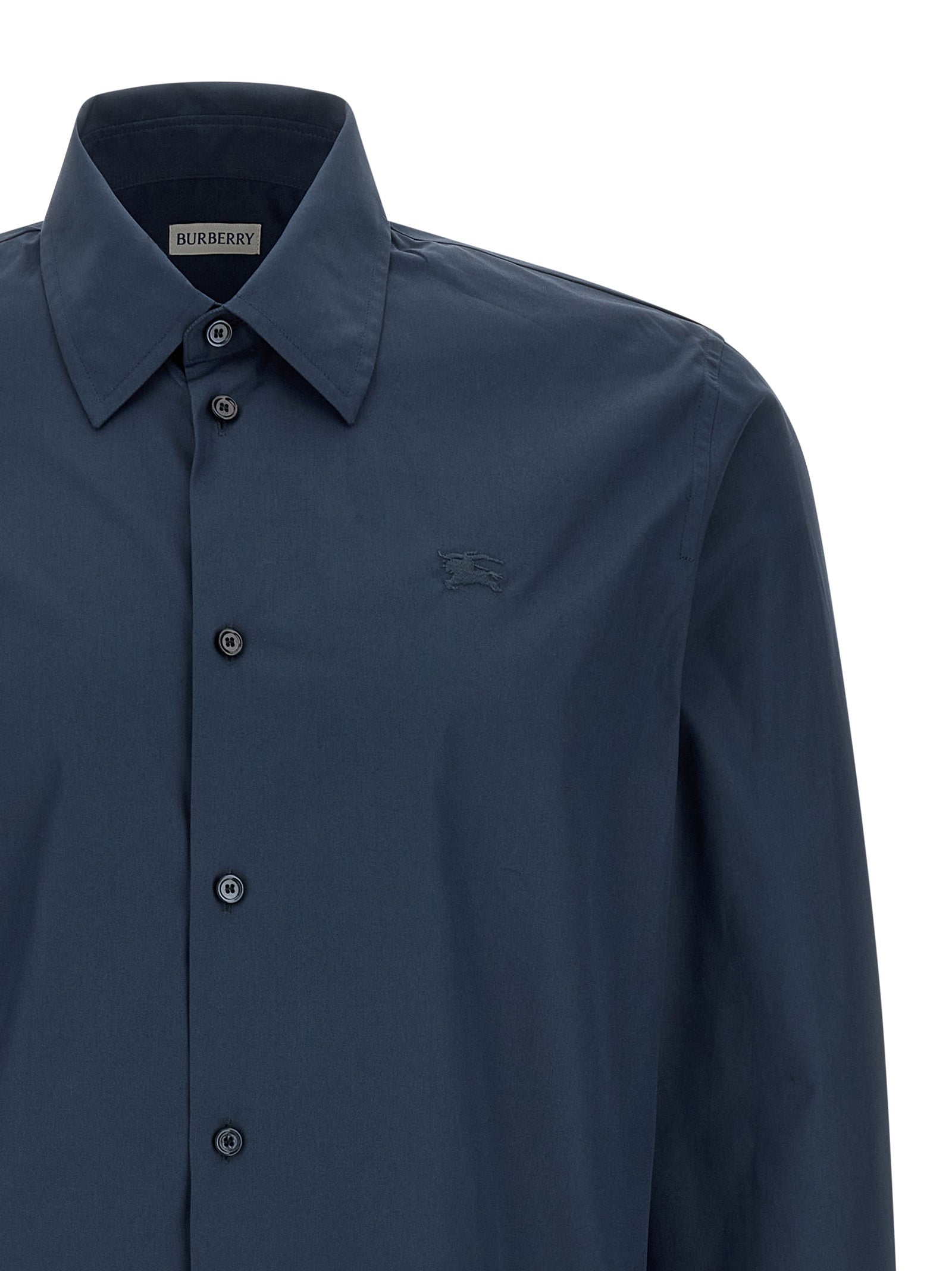 Blouse en coton bleu Burberry, élégante chemise pour femmes avec logo discret, tissu doux et coupe classique visible sur l'image.