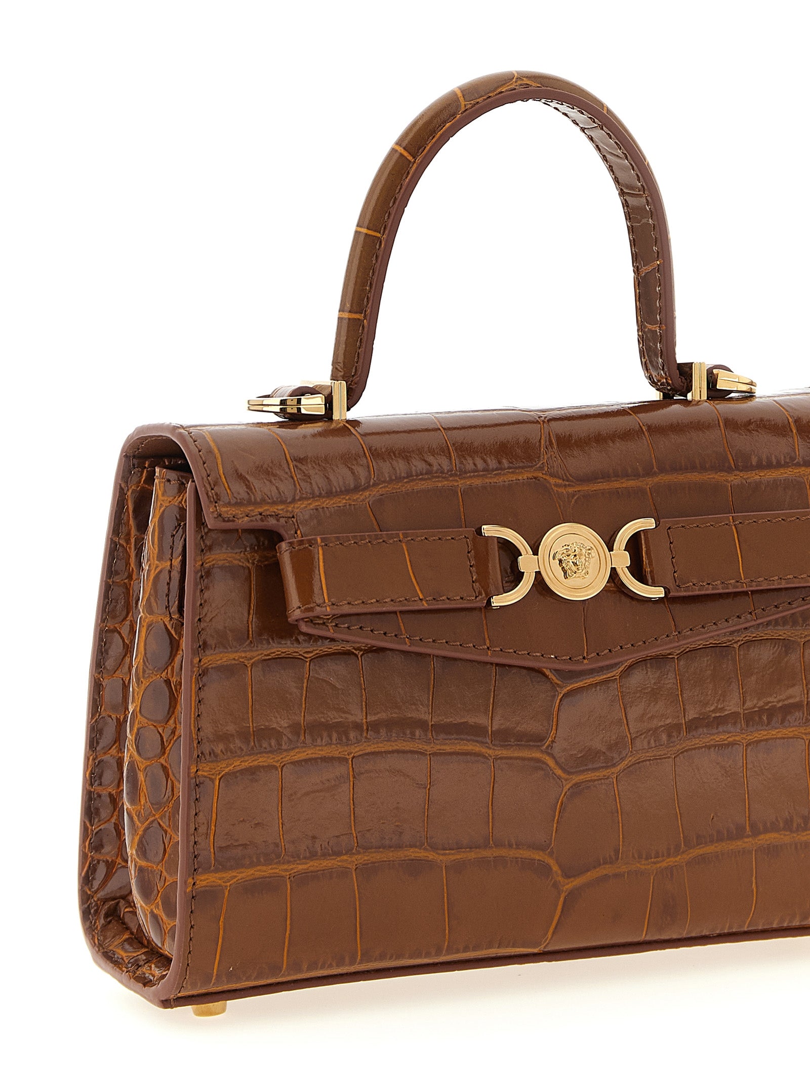 Sac à main en cuir de veau marron de Versace, élégant et sophistiqué, avec détails de design visibles.