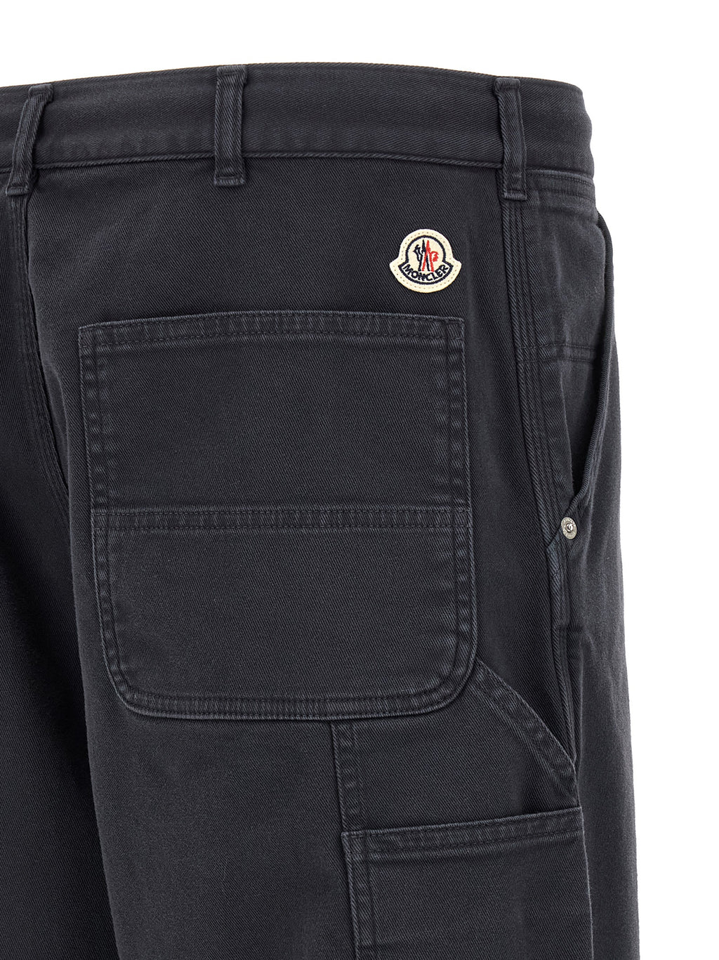 Pantalons cargo en coton bleu de la marque Moncler, style décontracté avec plusieurs poches visibles.