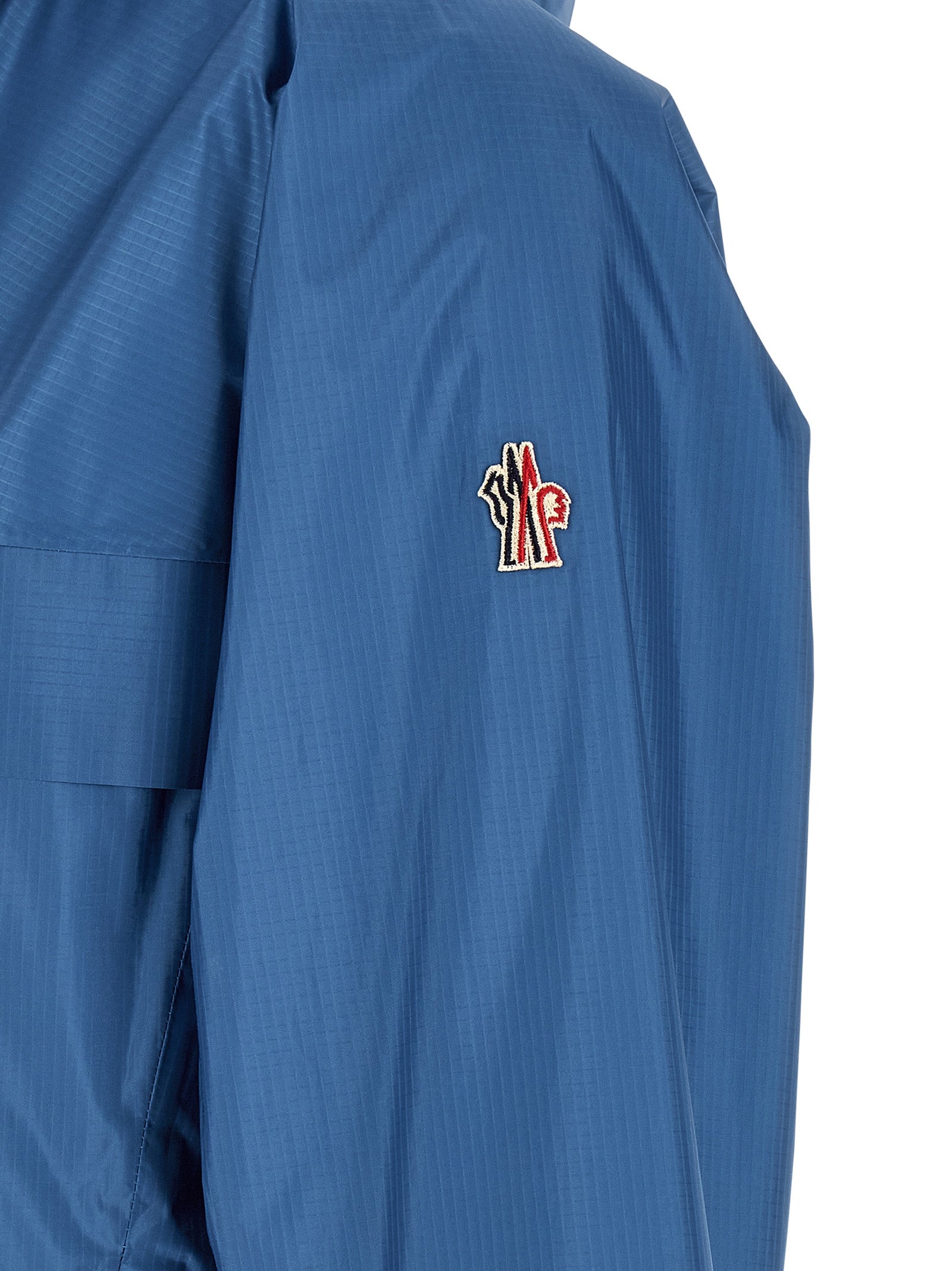 Veste en polyamide bleue Moncler Grenoble, coupe-vent et imperméable, avec capuche et fermeture zippée.