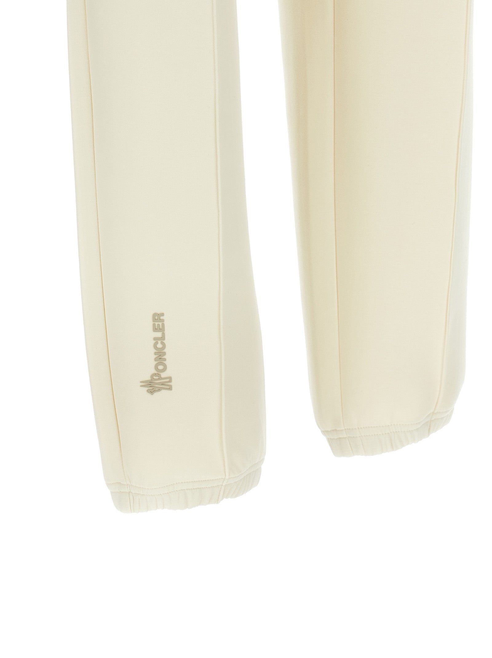 Pantalons de sport en polyester blanc Moncler Grenoble, joggers pour entraînement avec poches et taille élastique.