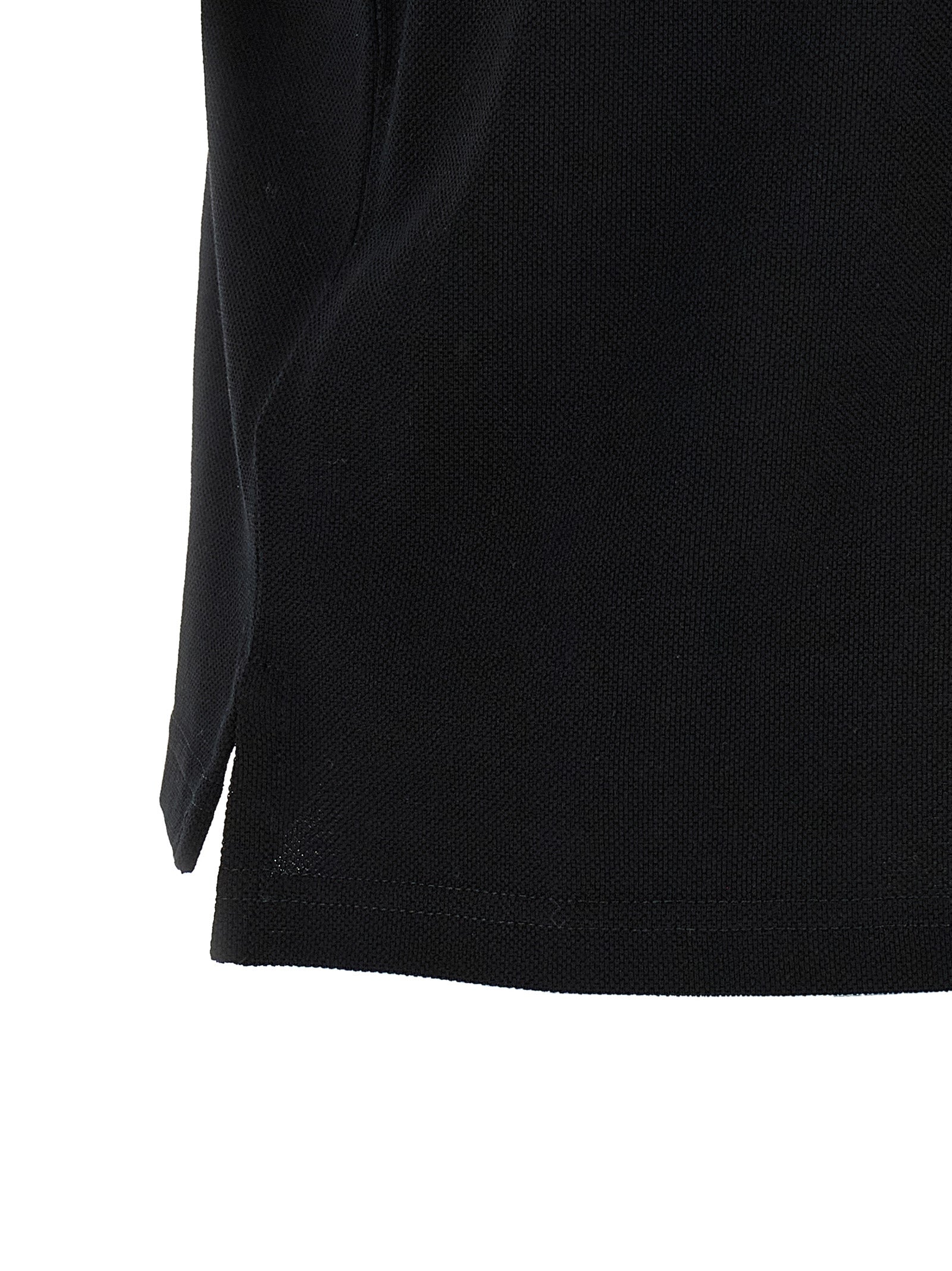 Chemise polo en coton noir de Saint Laurent, élégante et décontractée, avec col classique et logo discret.