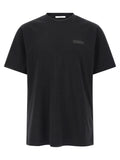T-shirt noir en coton Givenchy, coupe classique avec logo discret, porté sur mannequin blanc.
