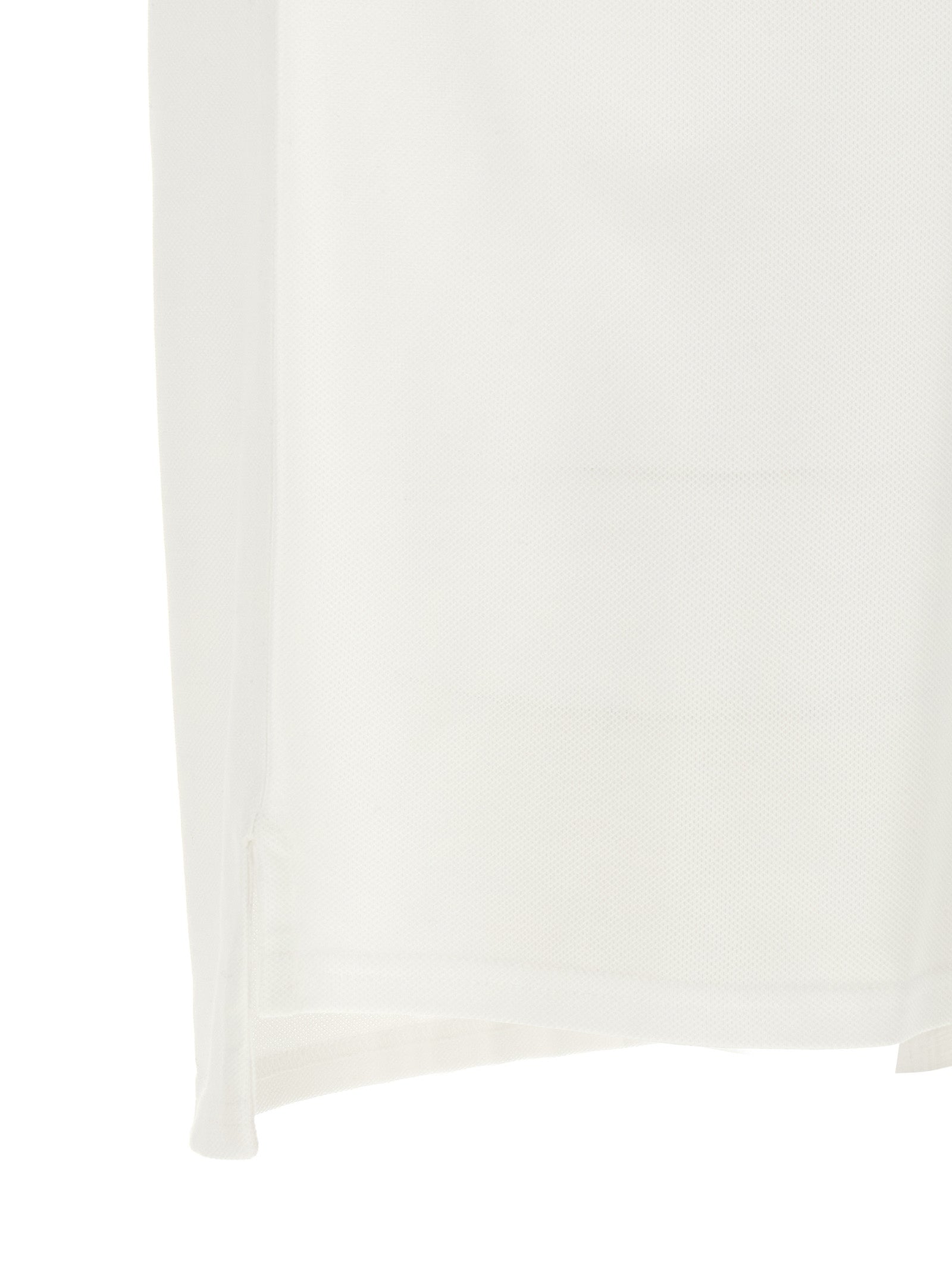 Chemise polo blanche en coton Givenchy, vue de face, avec col classique et logo discret sur la poitrine.