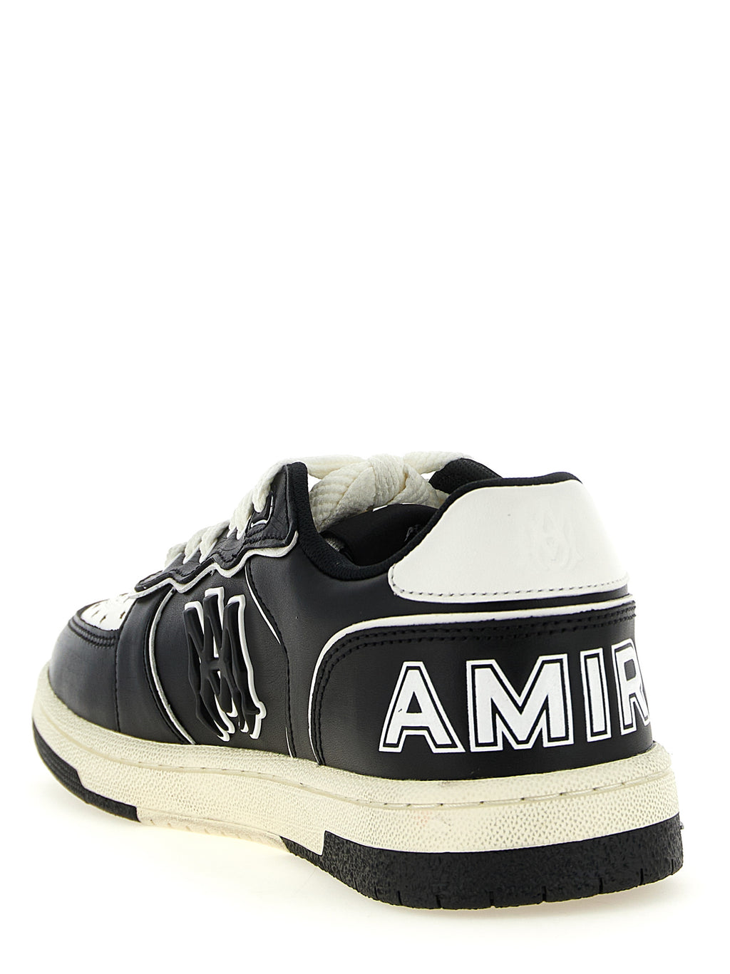 Sneakers basses Amiri en cuir bovin bicolore, avec design moderne et détails élégants, sur fond neutre.