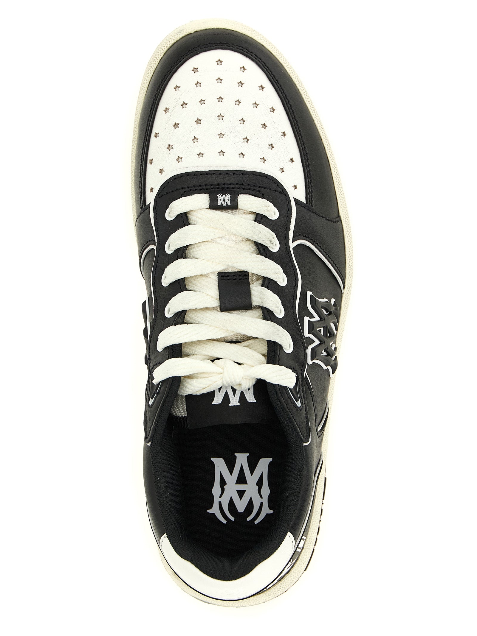 Sneakers basses Amiri en cuir bovin bicolore, style décontracté et moderne, visibles en gros plan.