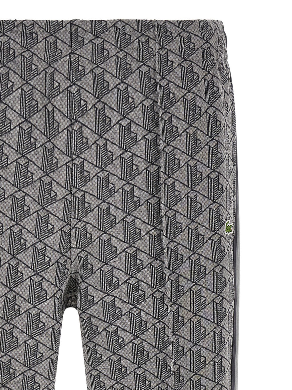 Pantalons de jogging gris en polyester de Lacoste, pantalon de sport pour homme avec logo crocodile visible.