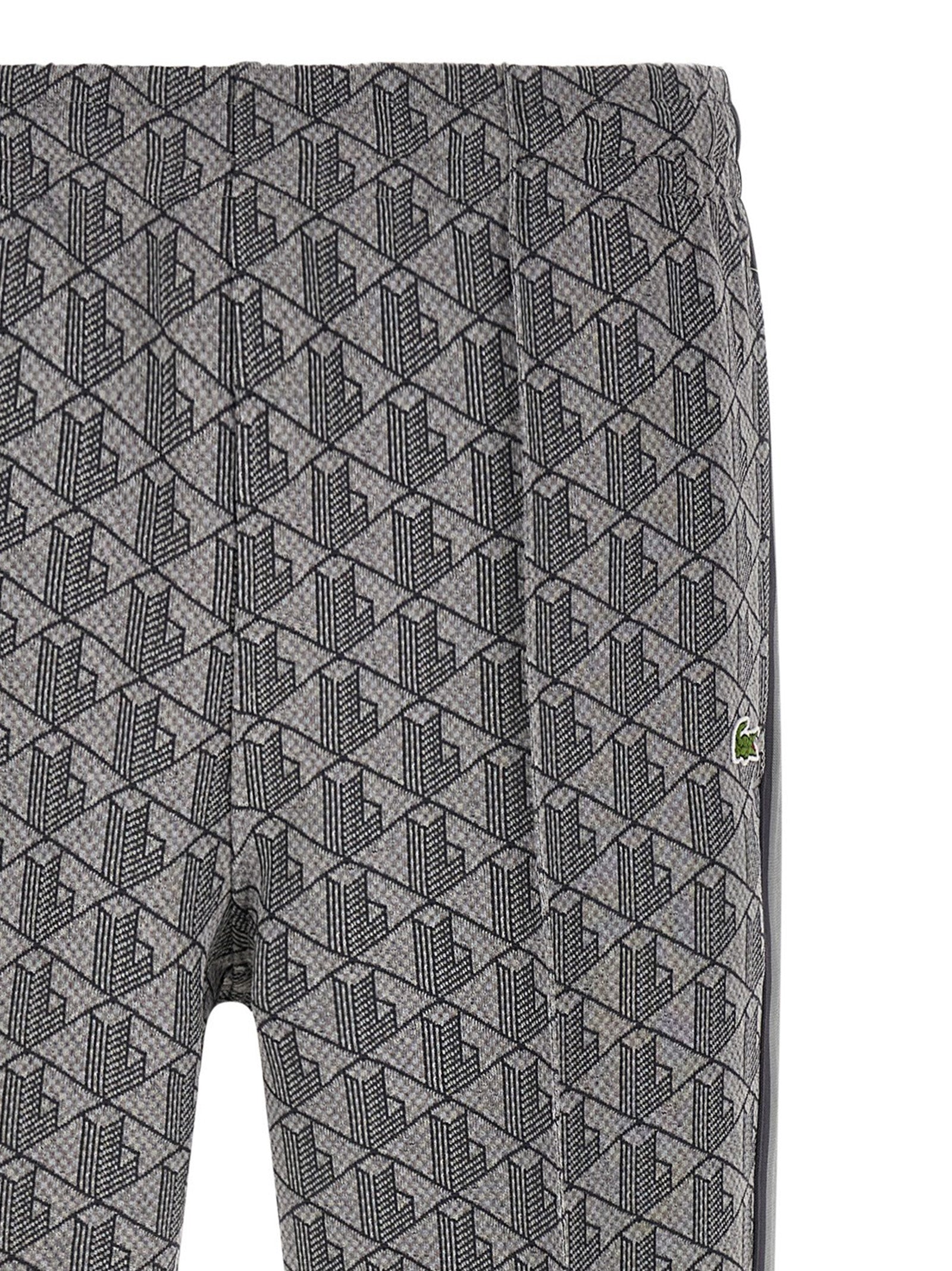Pantalons de jogging gris en polyester de Lacoste, pantalon de sport pour homme avec logo crocodile visible.