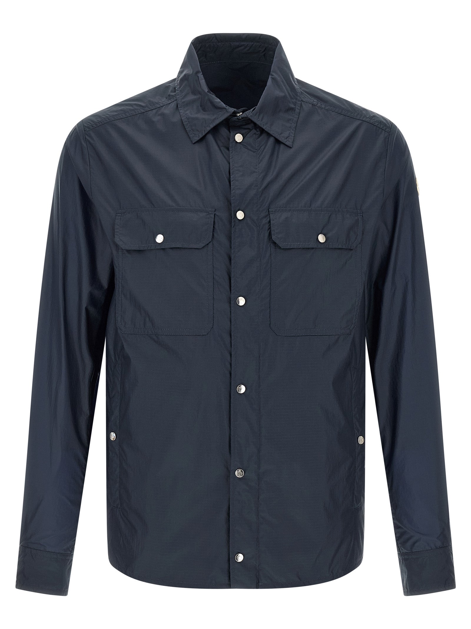 Blouse en polyamide bleue Moncler avec détails élégants, visible sur cette image.