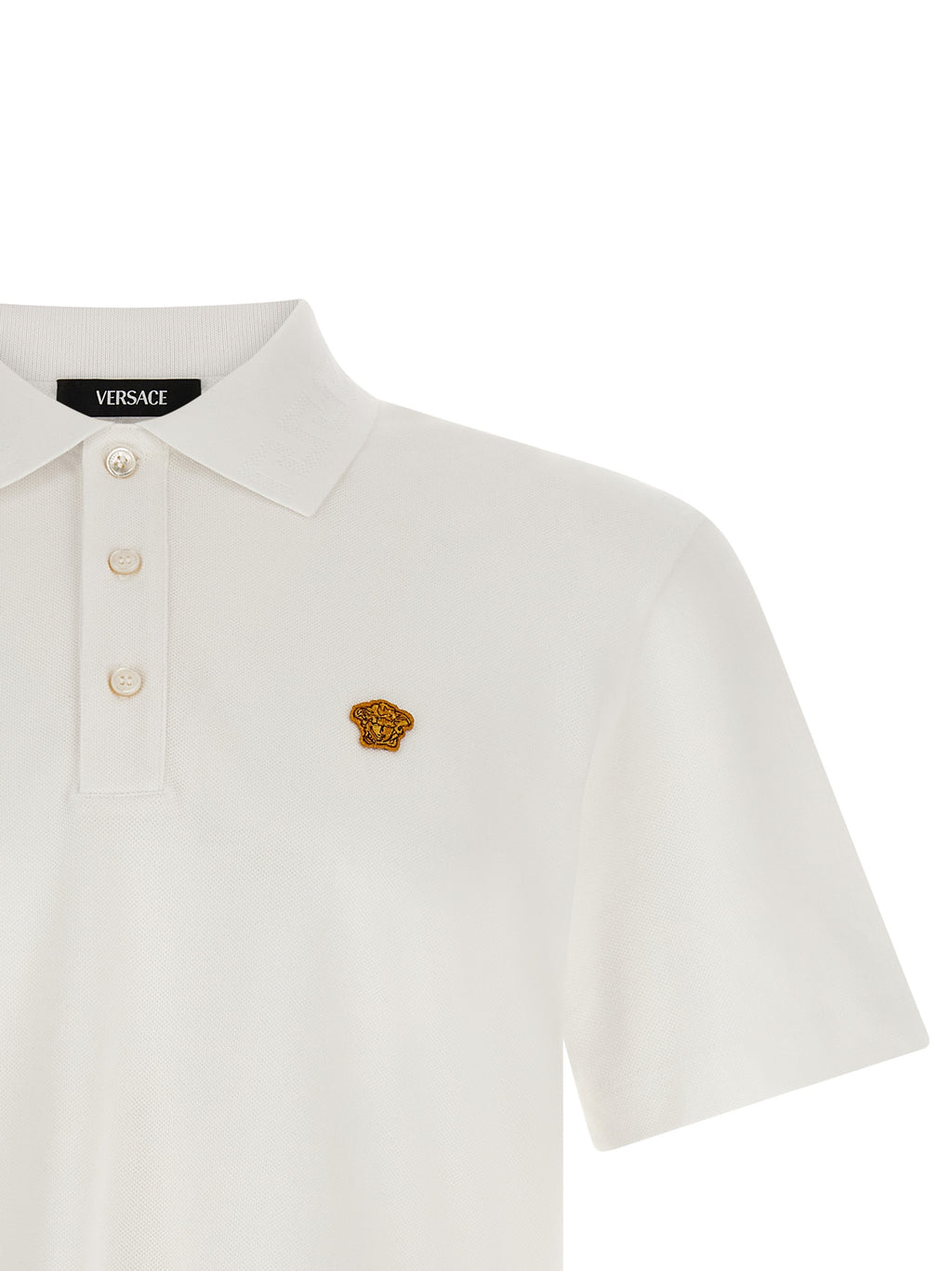 Chemise polo blanc en coton de la marque Versace, vue de face avec col et boutons visibles, tissu doux et élégant.