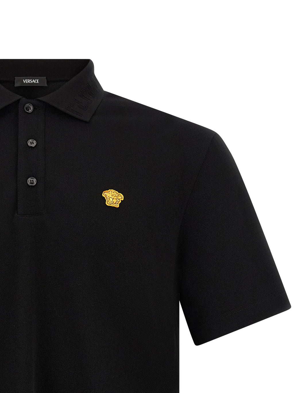 Chemise polo noire en coton de la marque Versace, détails élégants et logo visible sur le devant.