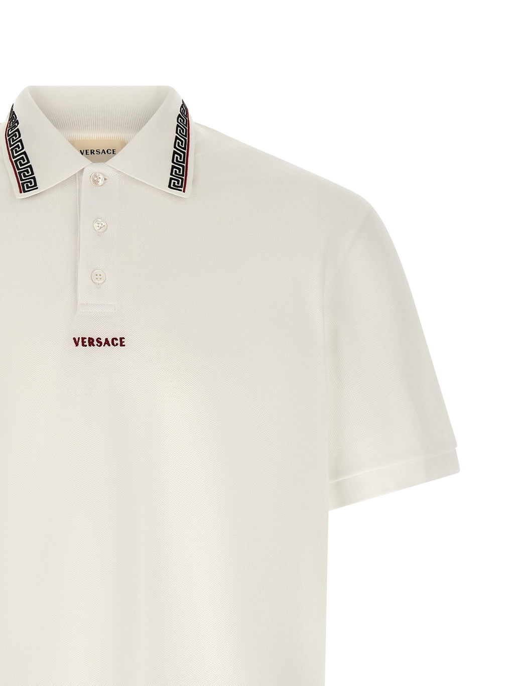 Chemise polo blanche en coton de la marque Versace, avec logo discret sur la poitrine, vue de face.