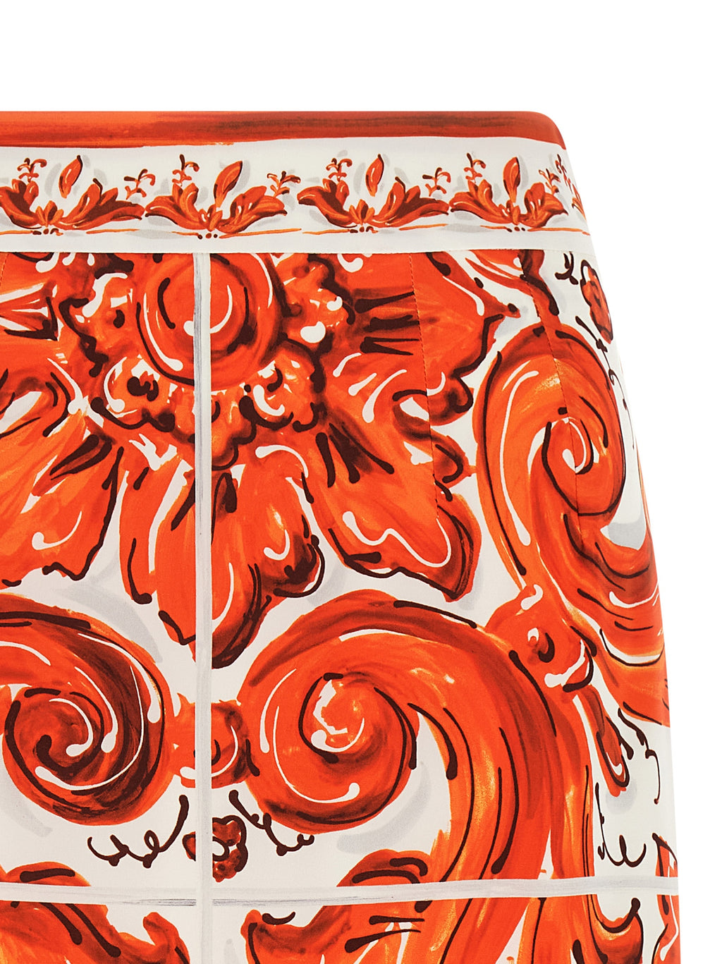 Jupe midi en soie orange de Dolce & Gabbana, coupe élégante et fluide, portée avec un style sophistiqué.