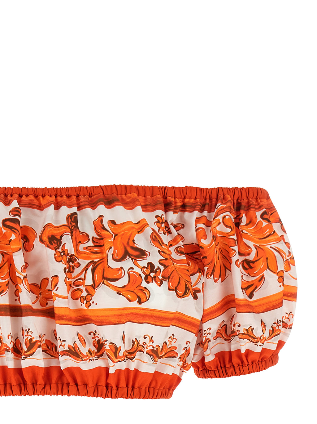 Blouse en coton orange de Dolce & Gabbana avec manches longues et détails élégants, portée sur un mannequin.