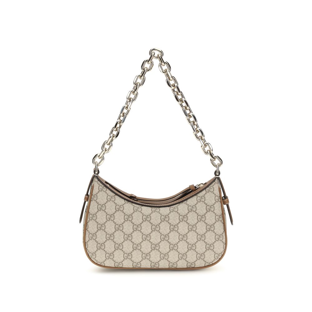 Sac à main en tissu beige de Gucci, avec poignées et détails élégants, idéal pour un style sophistiqué.