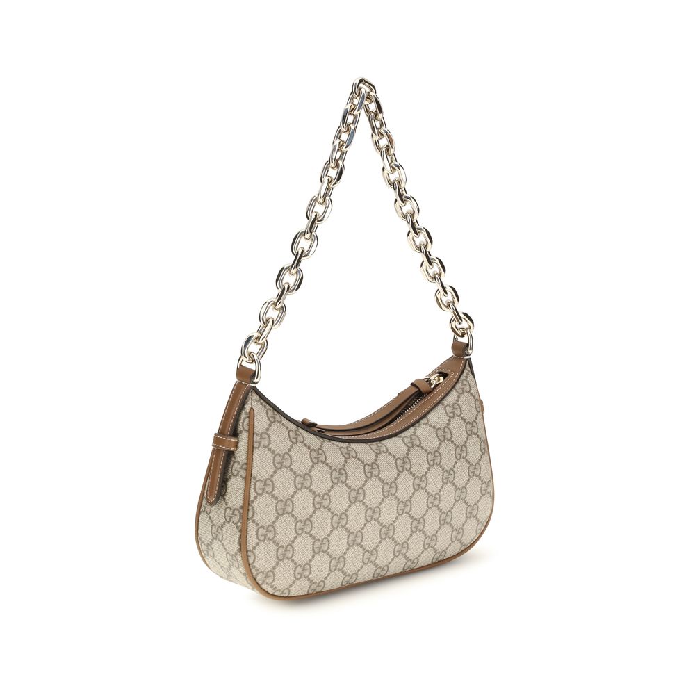 Sac à main en tissu beige de Gucci, élégant et classique, avec détails en cuir et logo Gucci visible.