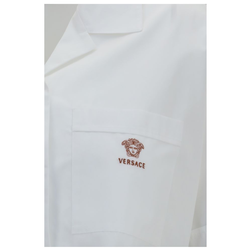 Chemise blanche en coton de la marque Versace, à col classique et boutons, pour homme élégante et sophistiquée.