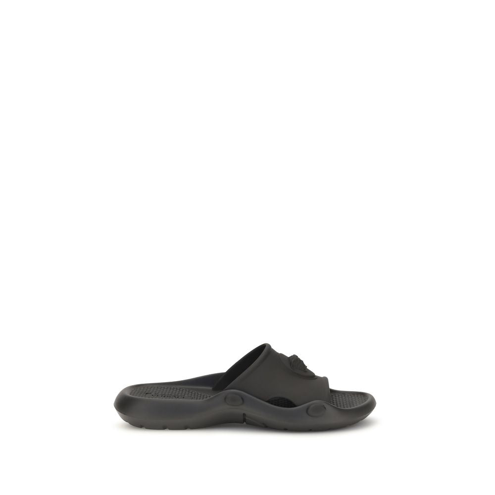 Sandales en caoutchouc noires Versace avec logo emblématique, confortables et stylées pour un look tendance.