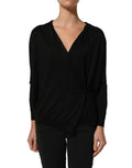 Blouse noire en soie à manches longues et drapée de Dolce & Gabbana, visible avec détail élégant et tissu fluide.