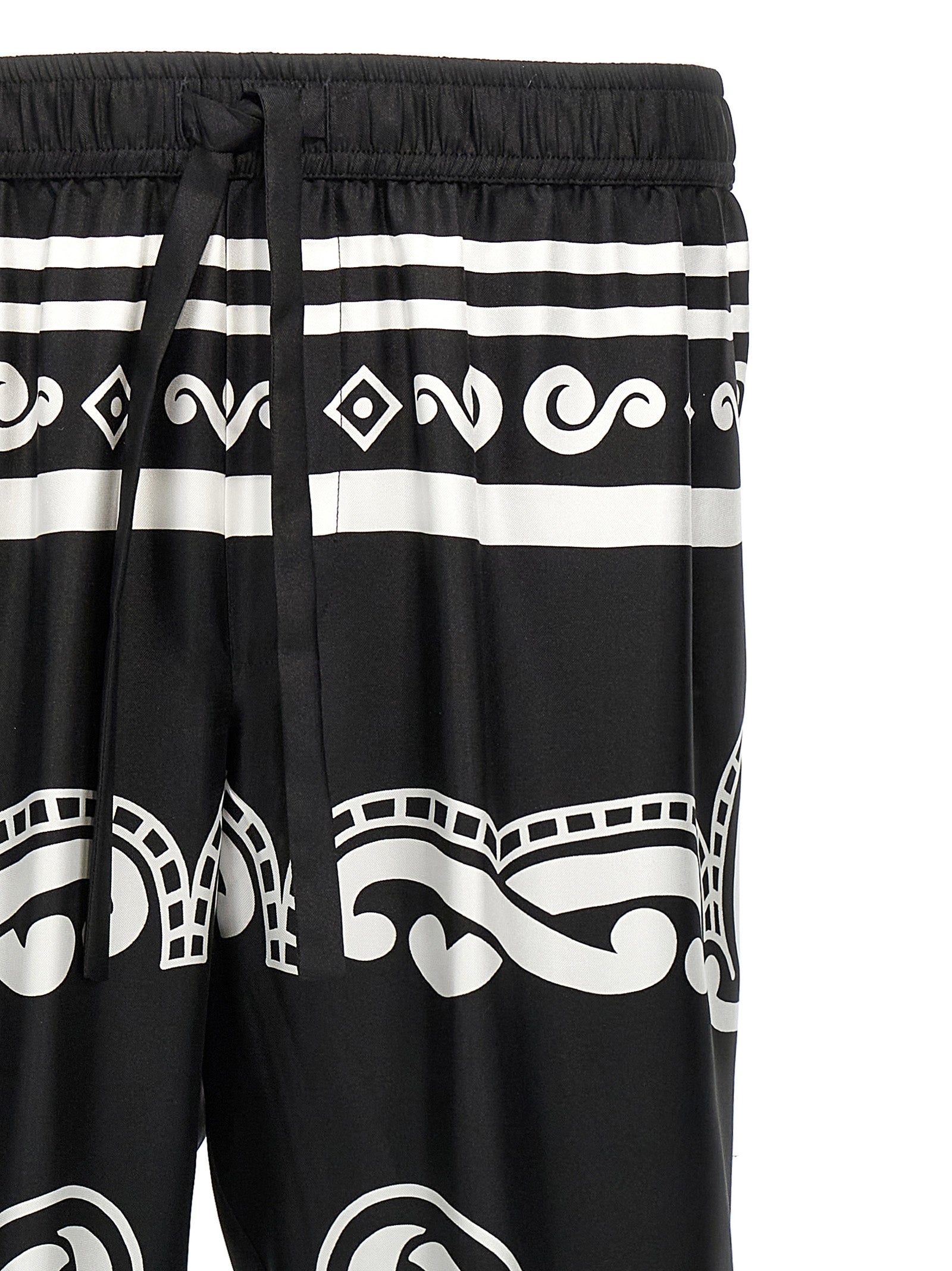 Pantalon décontracté en soie bicolore de Dolce & Gabbana, coupe élégante et tissu fluide, couleur bleu et beige.