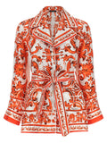 Blouse en soie orange Dolce & Gabbana, élégante et fluide, avec des détails raffinés visibles sur l'image.